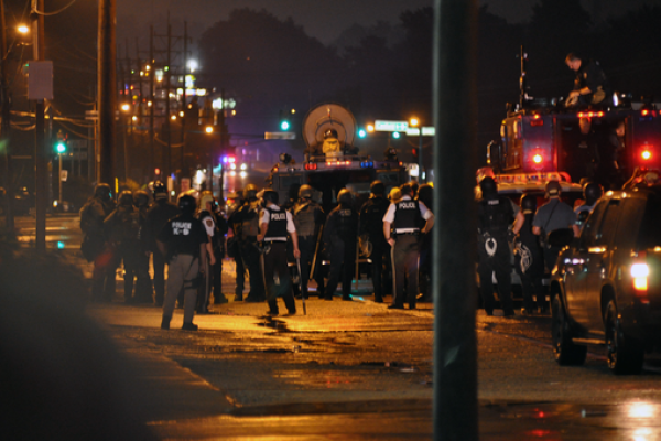 Moving the line of police vehicles forwards.